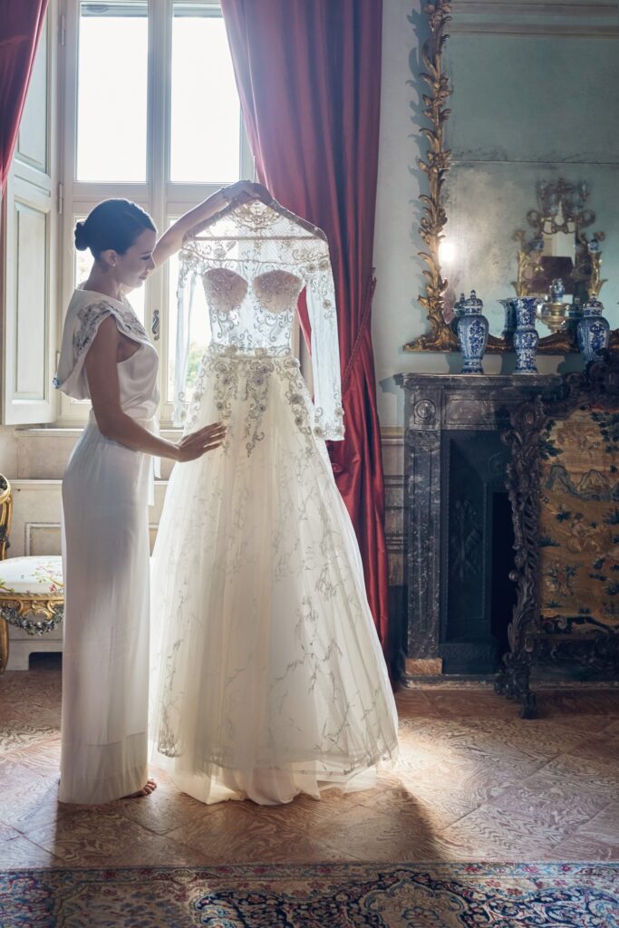 Bride holding her wedding dress at Villa Balbiano at Lake Como in Italy