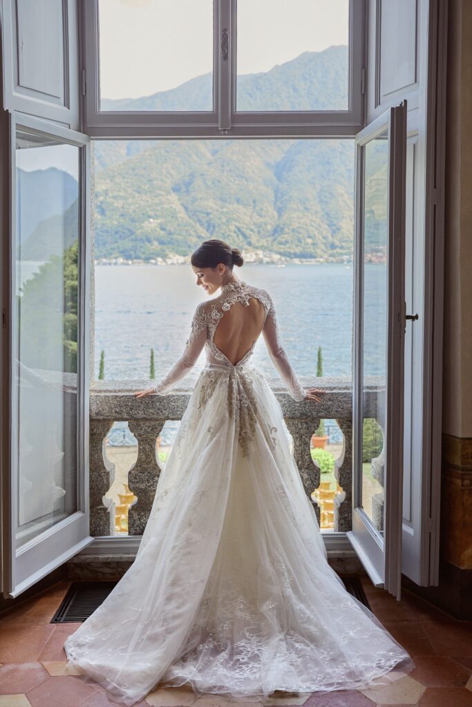 Bride standing in the window posing for her wedding portrait at Villa Balbiano at Lake Como Italy